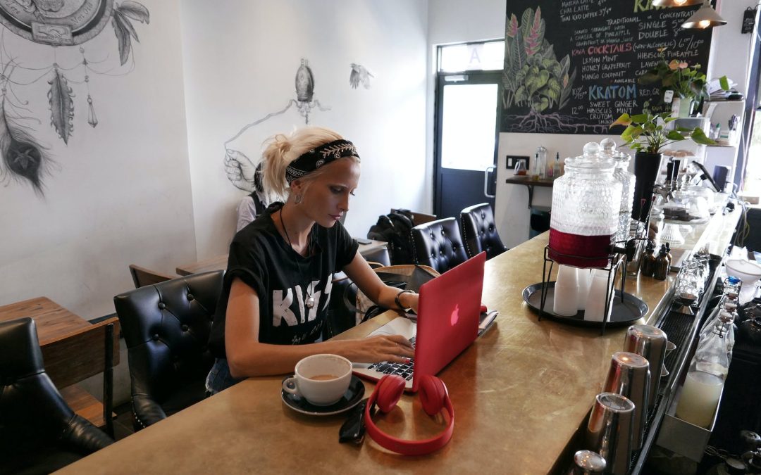 woman wears black kiss print crew neck shirts sits